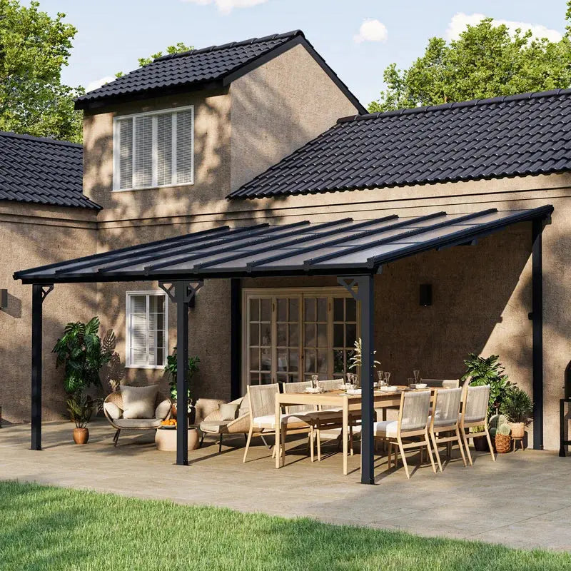 Modern patio with outdoor dining set, lounge chairs, and pergola next to a house.