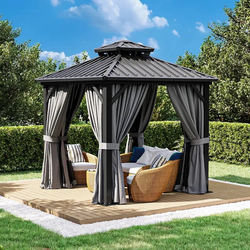 Modern outdoor gazebo with curtains and wicker patio furniture on a wooden deck