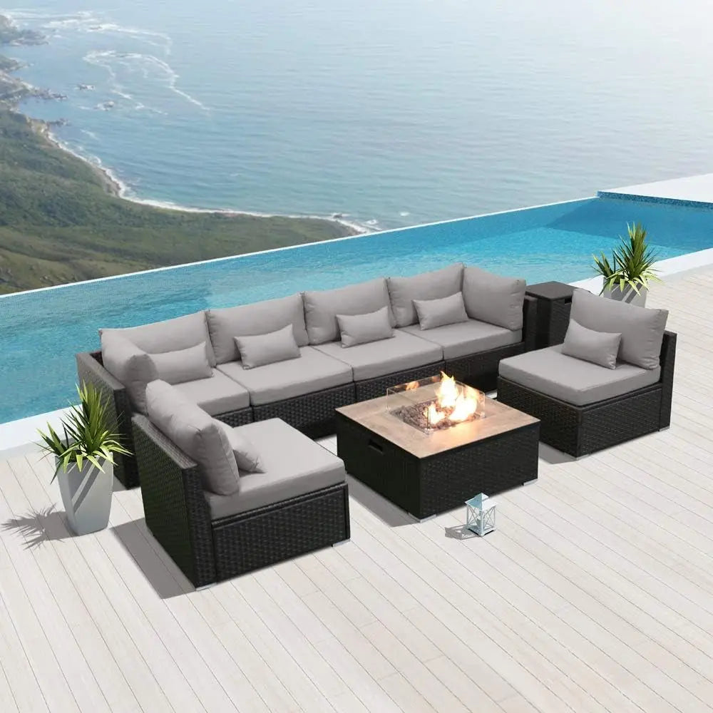 Modern outdoor patio furniture set with fire pit by infinity pool and ocean view
