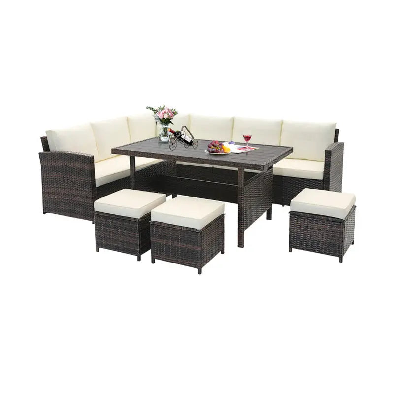 ELVORA Living 7-piece coastal dining set featuring a brown wicker frame, cream cushions, rectangular table, and four stools.